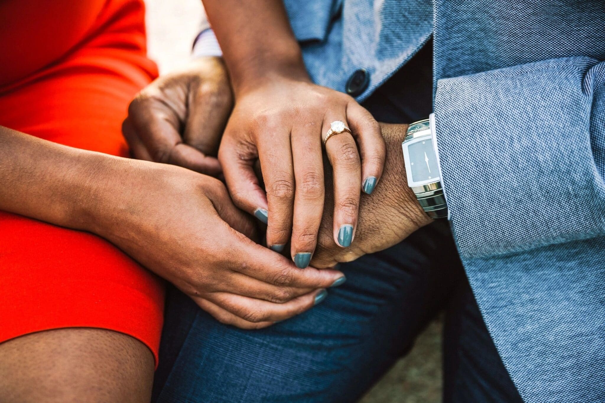 A close up of two people holding hands