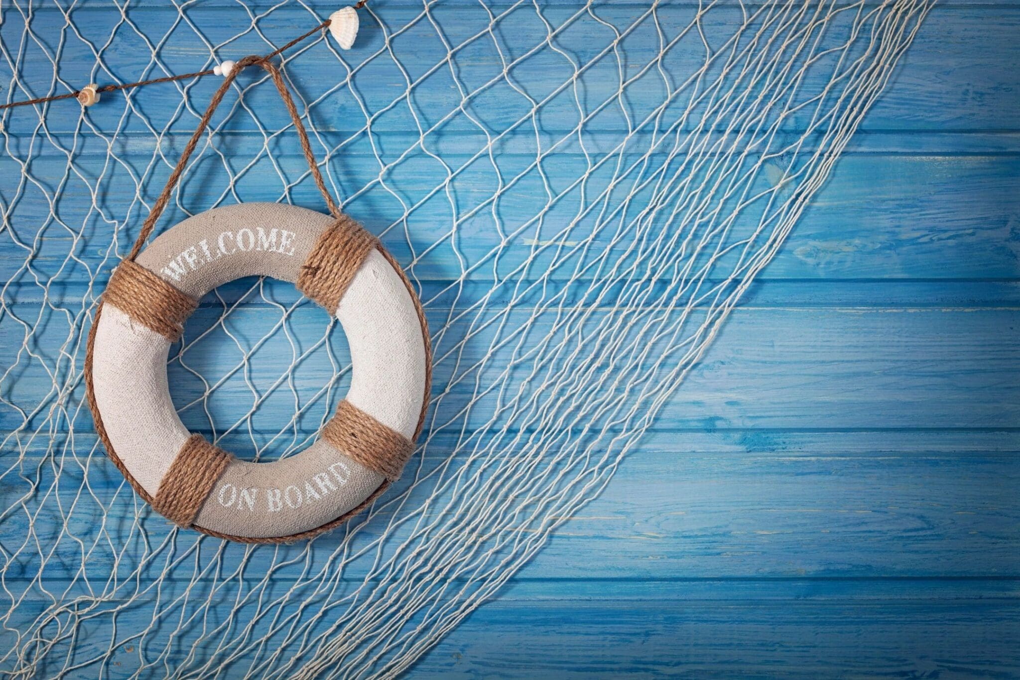 A life preserver hanging on the side of a net.