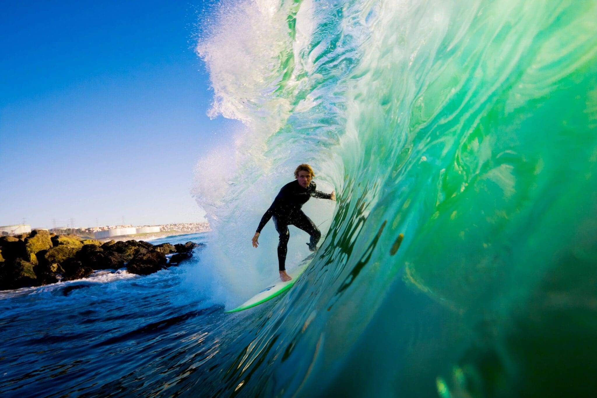 A man riding on top of a wave in the ocean.