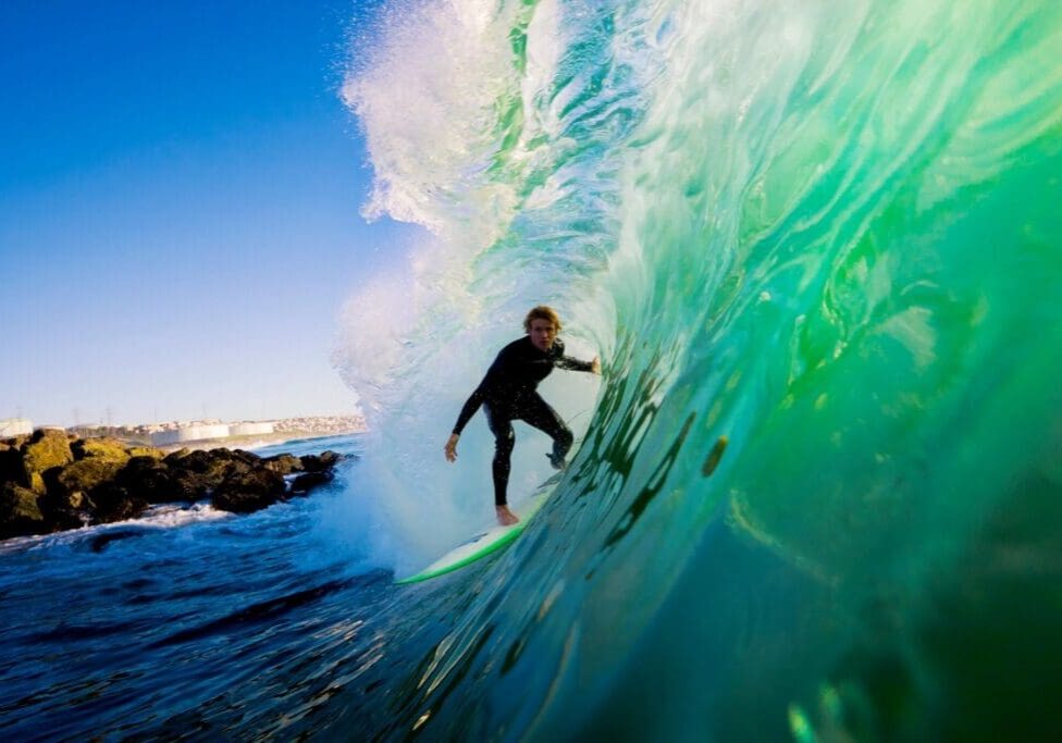 A man riding on top of a wave in the ocean.